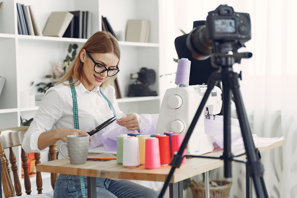 woman sitting studio sew cloth